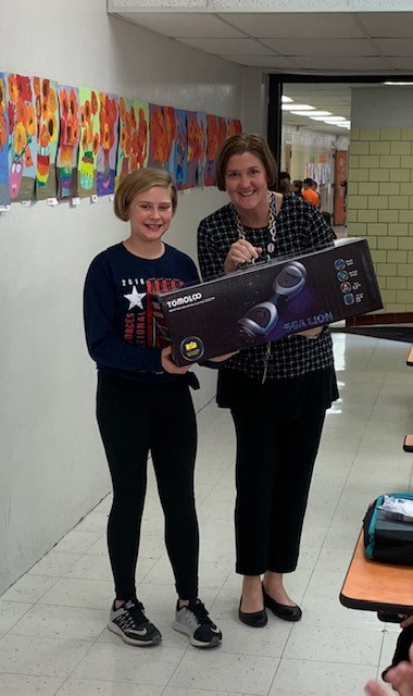 girl and teacher holding box